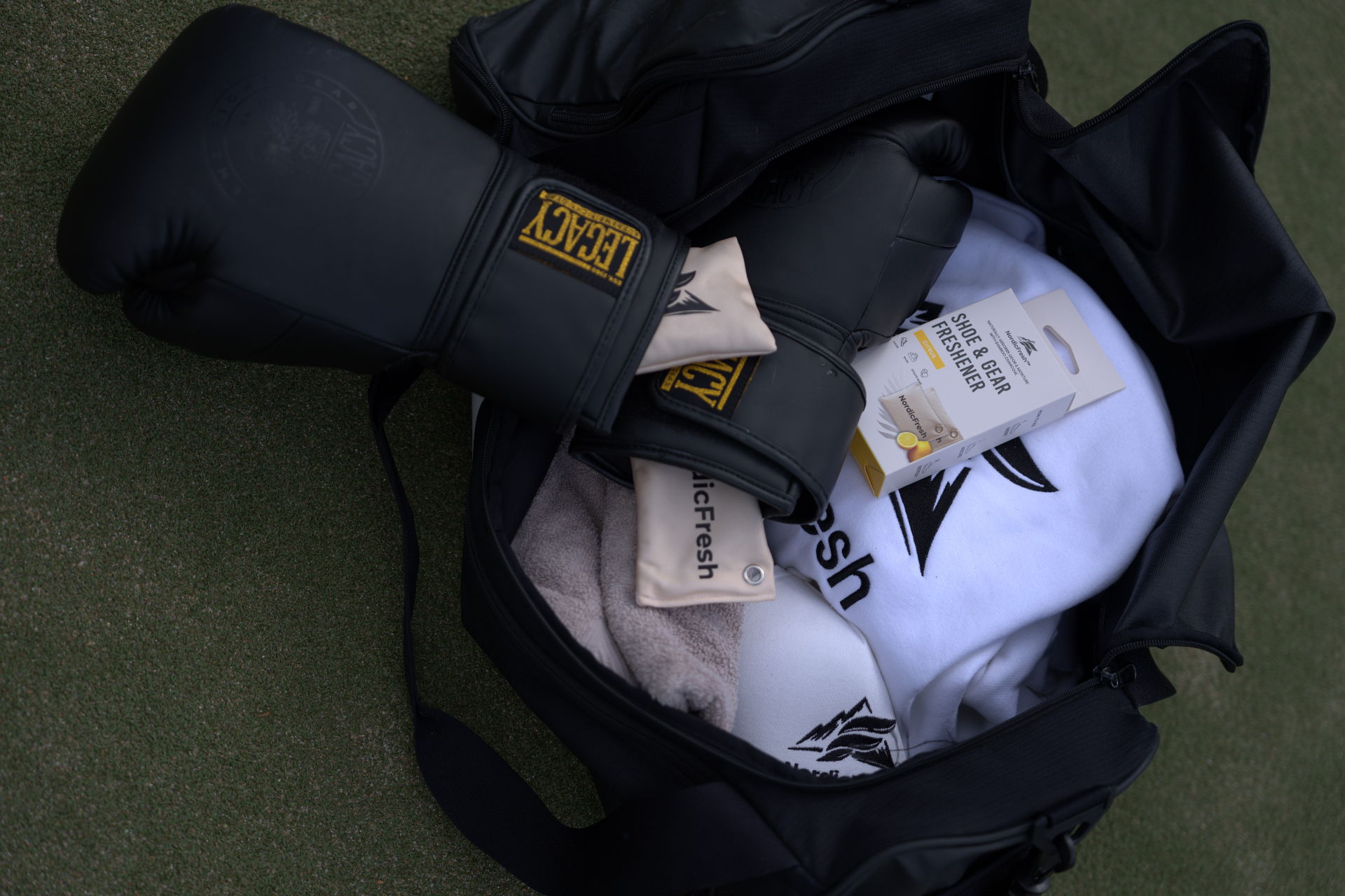 NordicFresh Citrus bamboo charcoal odor absorber inside a boxing gym bag with gloves and wraps