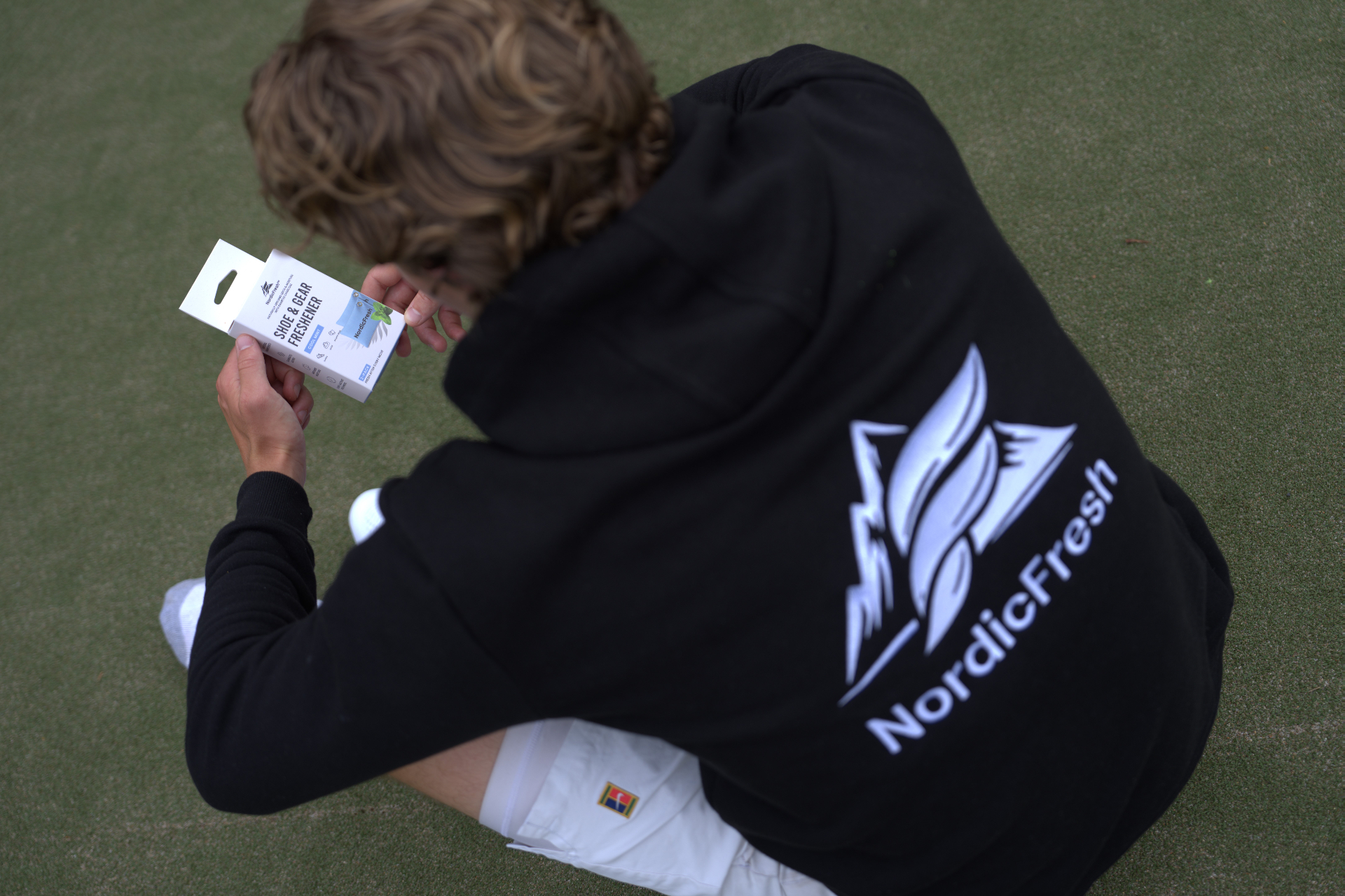 NordicFresh shoe & gear freshener courtside with tennis shoes, racket and gym bag, designed for active athletes